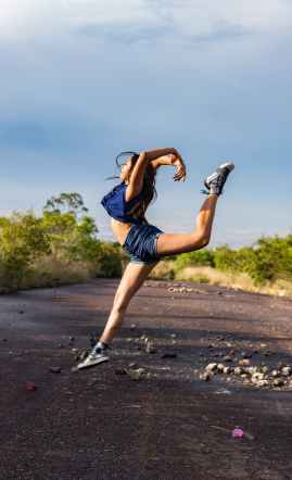 dancing woman wearing blue vest